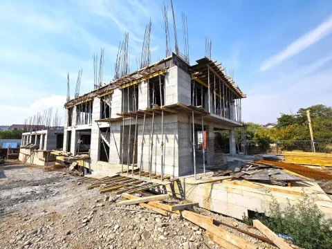 View of a building under construction with concrete structure and scaffolding. - image 9