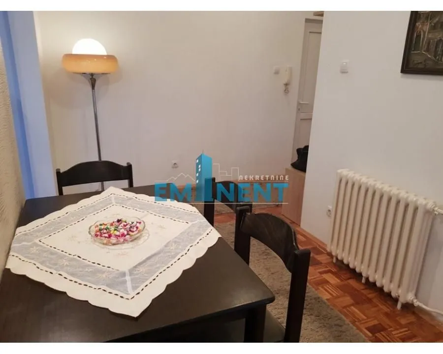 Dining area with a table, chairs, and a floor lamp.