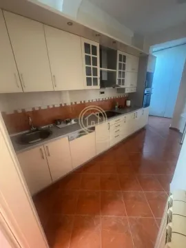 Kitchen with light cabinets and ceramic tiles on the floor and walls. - image 7