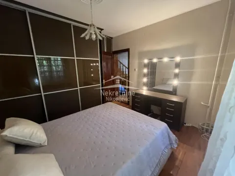 Bedroom with a large double bed, wardrobe, and illuminated vanity mirror. - image 15