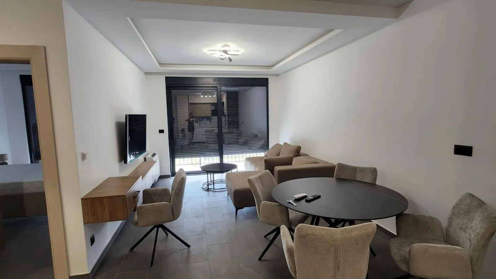 Living room with dining area and sofa set.