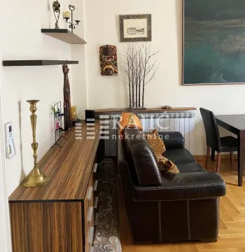 Living room with a sofa and dining table. - image 2