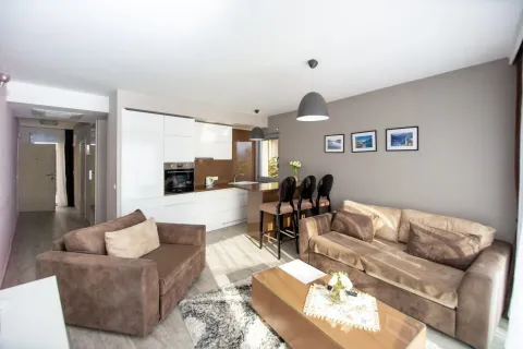 Spacious living room connected to the dining area and kitchen. - image 3