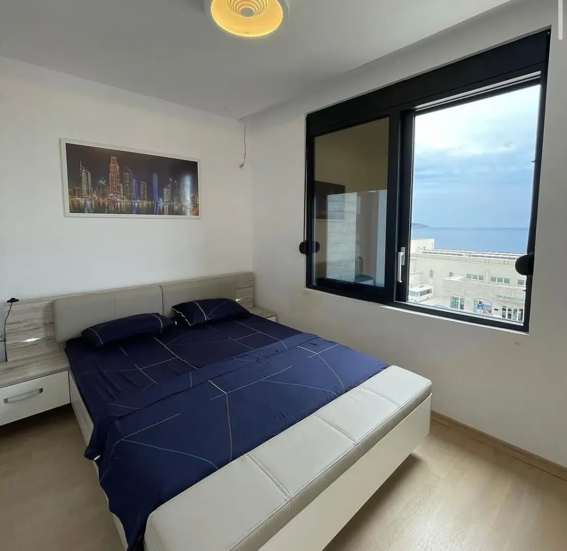 Furnished bedroom with a double bed and sea view.