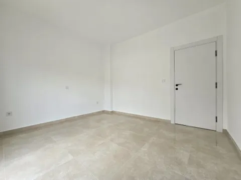 Empty bright room with ceramic tiles and a white door. - image 17