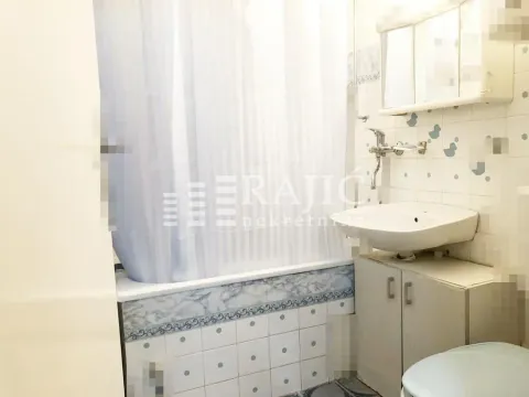 Small bathroom with a sink, cabinet, and bathtub with a curtain. - image 19