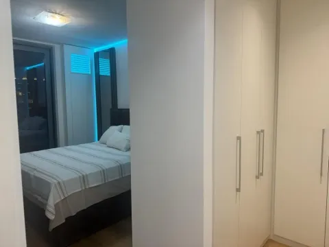 View from the hallway into the bedroom with built-in wardrobes. - image 8