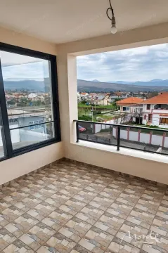 Enclosed balcony with a view of the settlement and mountains. - image 15