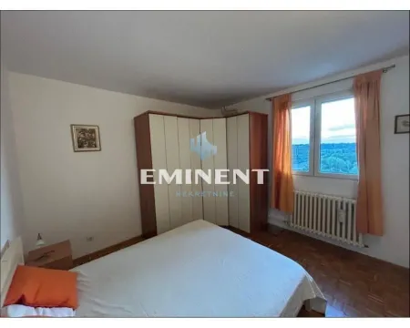 Furnished bedroom with a double bed, large wardrobe, and a window. - image 5