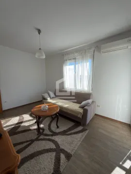 Living room with a sofa, coffee table, and rug. - image 3
