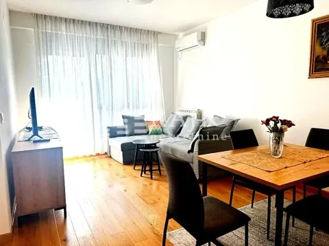 Living room with a sofa and a dining table. - image 2