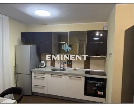 Kitchen with dark and white cabinets and built-in appliances. - image 6