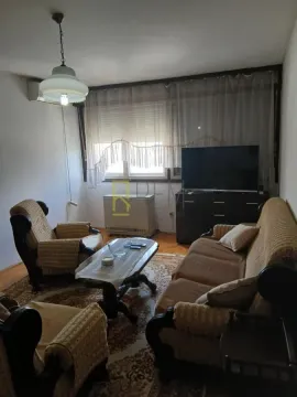 Living room with seating furniture, coffee table, and television. - image 2