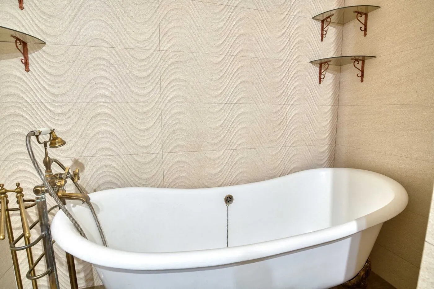 Bathroom with a freestanding bathtub and retro faucets.