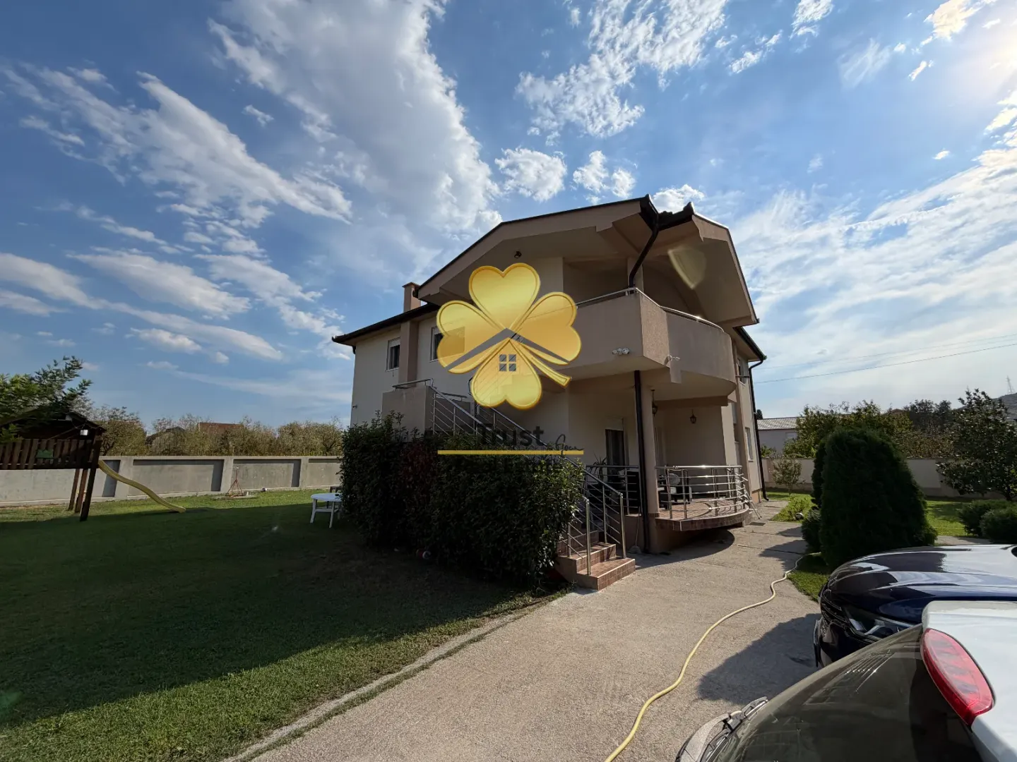 Exterior of a family house with a yard and terrace.