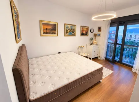 Bedroom with a double bed, artwork on the wall, and access to the terrace. - image 5