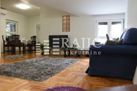 Spacious living room with a sofa set and a dining area in the background. - image 2