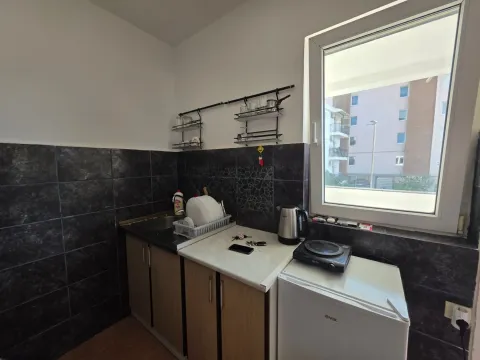 Small kitchen with a sink, refrigerator, and kitchen units. - image 12