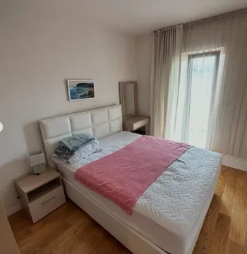 Bright bedroom with a double bed, nightstand, and access to the terrace. - image 8