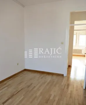 Empty room with hardwood floors and white walls. - image 9