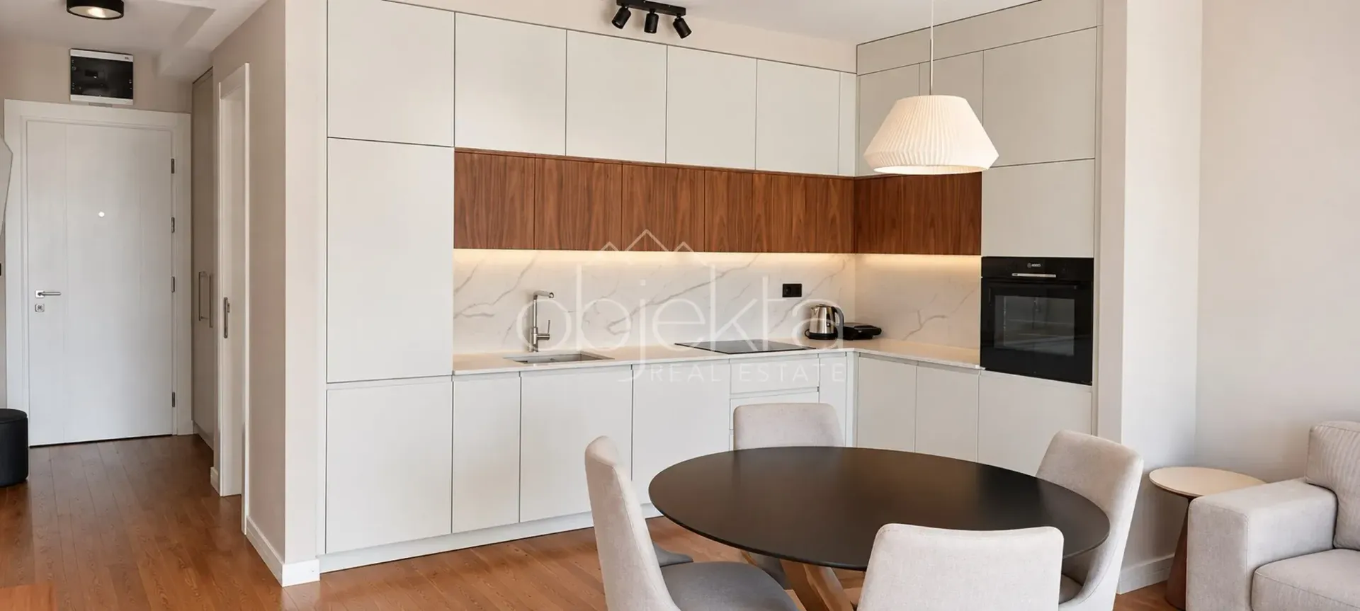 Modern kitchen with built-in cabinetry and a dining table.