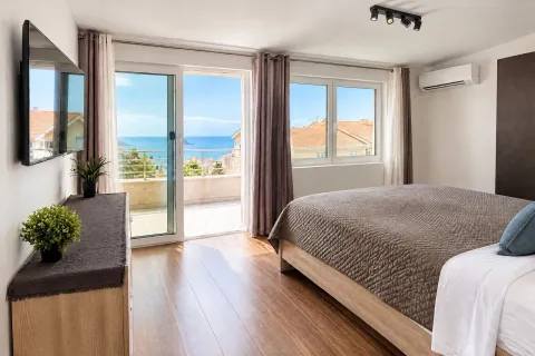 Bright bedroom with a double bed, TV, and access to a terrace with a sea view. - image 9