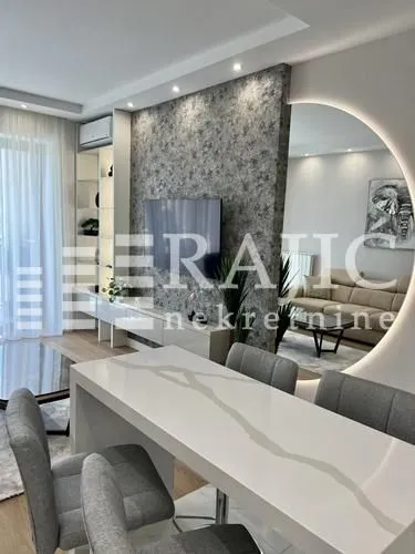 Modern living room with dining area and recessed lighting.
