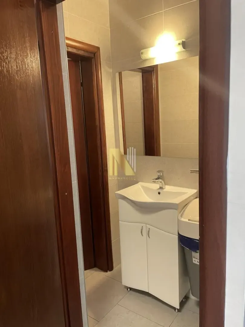 Smaller bathroom with a sink and a mirror.
