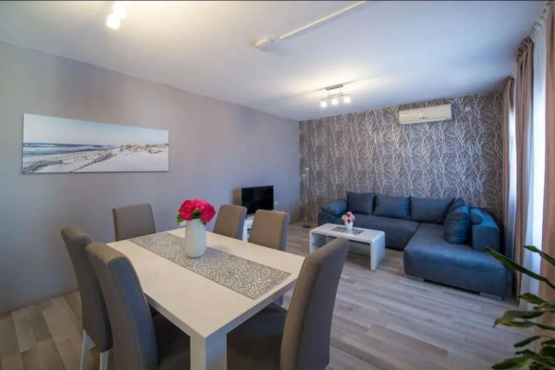 Living room with a sofa set and a dining table.