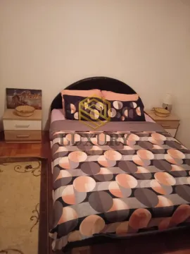 Bedroom with a double bed, nightstands, and an agency watermark overlaid on the bed. - image 7