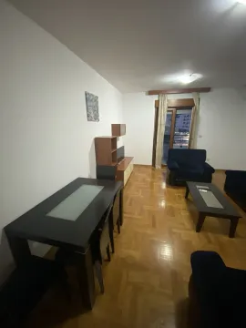 Living room featuring a dining table, parquet flooring, and balcony access. - image 5