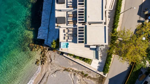 Aerial view of a seaside villa with a pool and terrace. - image 4