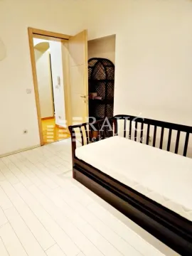 Small bedroom with a bed and an open passage to the hallway. - image 5
