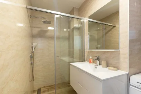 Modern bathroom with a walk-in shower and vanity. - image 14