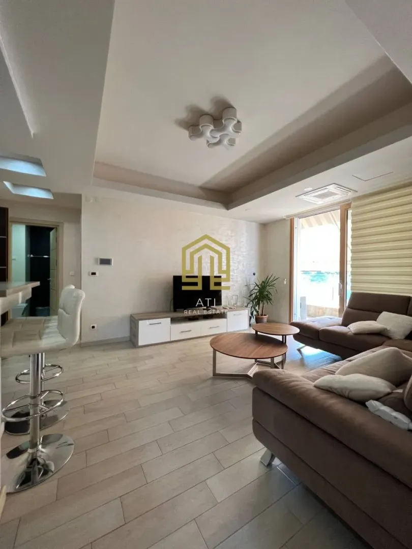 Spacious and bright living room with a sofa and dining area.