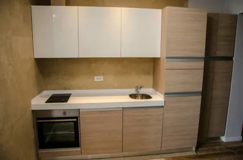 Modern kitchen with light cabinets and built-in appliances. - image 5