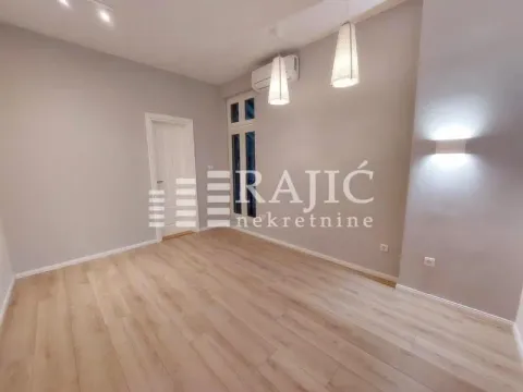 Empty room with laminate flooring and recessed lighting. - image 6