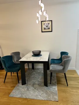Dining area with a table and four chairs. - image 5