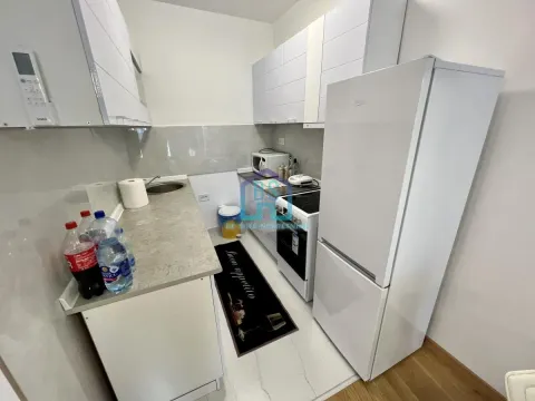 Smaller white kitchen with a refrigerator and stove. - image 5
