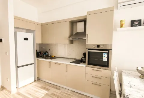 Modern kitchen with light cabinetry and built-in appliances. - image 4