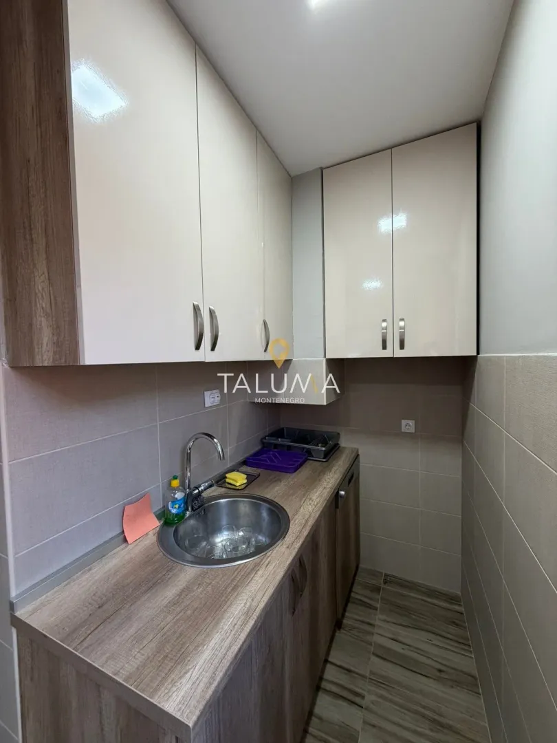 Small kitchen with a sink and wall cabinets.