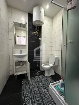 Bathroom with a sink, toilet, water heater and shower cabin. - image 3