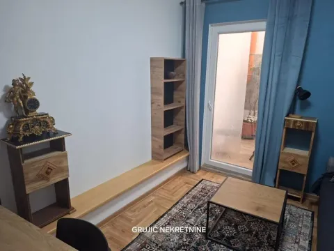 Living room with wooden furniture and access to the terrace. - image 7