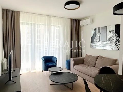 Modern and bright living room with a sofa and dining table. - image 2