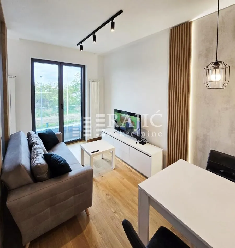 Living room with a sofa and dining area.