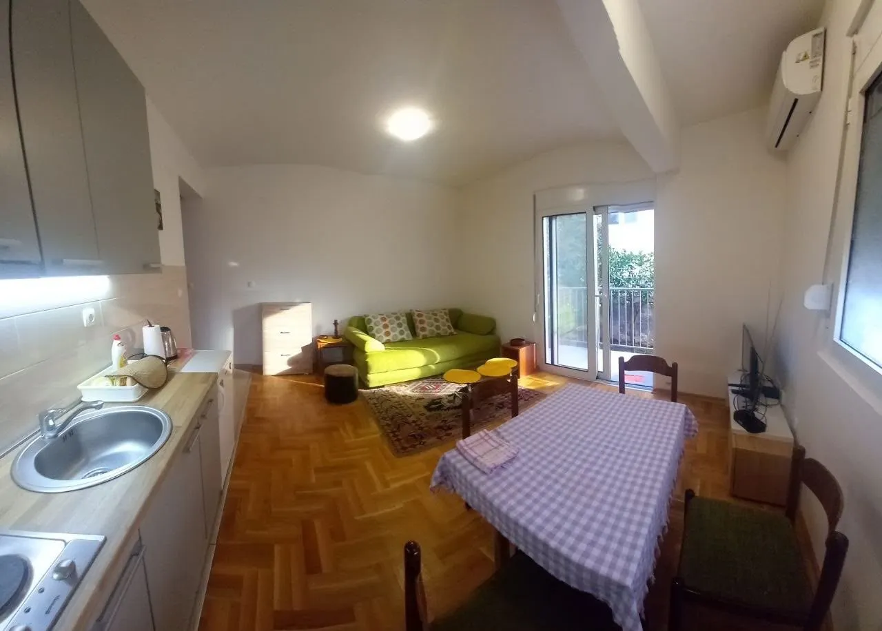 Living room with kitchen and dining area.