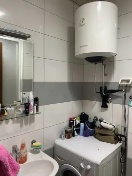 Part of a bathroom with a washing machine, mirror, and boiler. - image 13