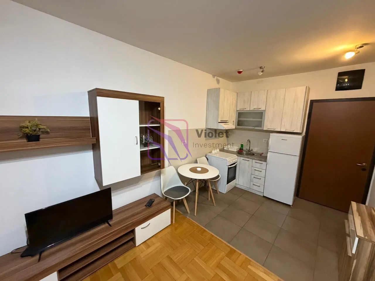 Living room with kitchen and dining table.