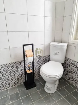 View of the bathroom with a toilet and a toilet paper holder. - image 4