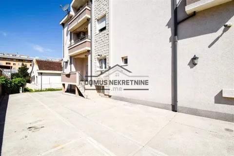 Exterior view of the residential building with a concrete yard and entrance. - image 12